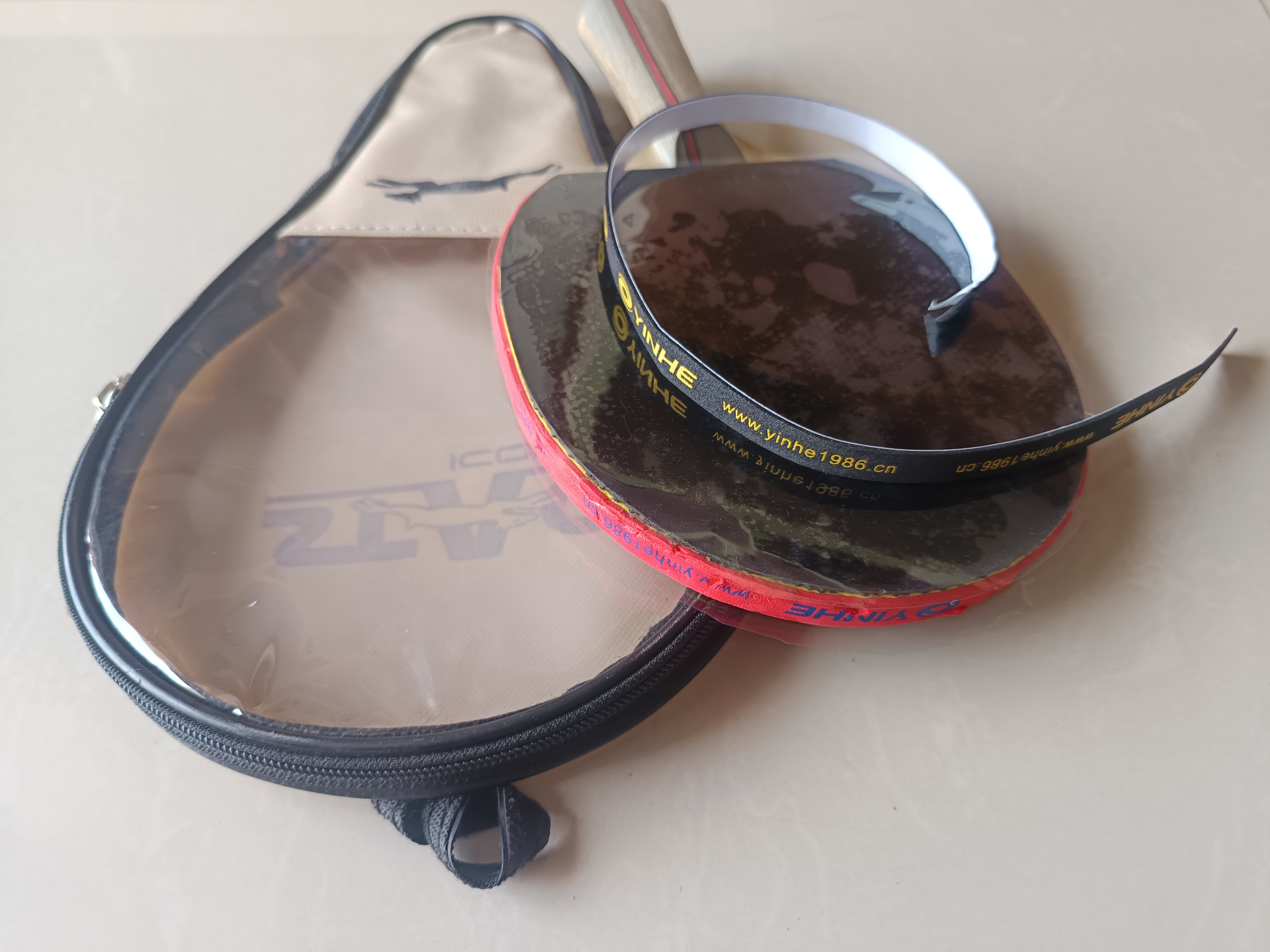 Table tennis racket edge tape fitted around a racket blade